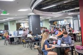 FSU students studying at a large table inside Strozier Library