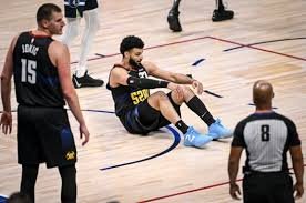 Jamal Murray dribbling during an intense NBA game